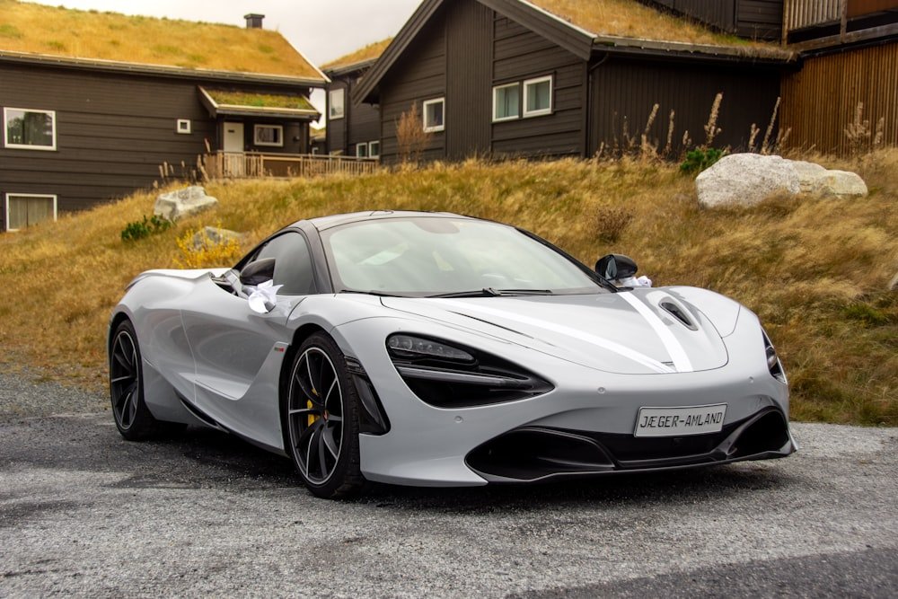 McLaren 720S, Project Glacier, white track-pack coupe against alpine houses